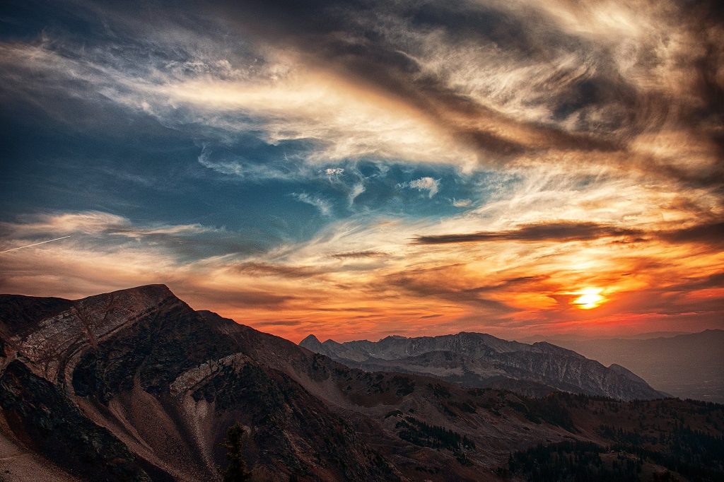 Mountain Peaks and Sunset through clouds